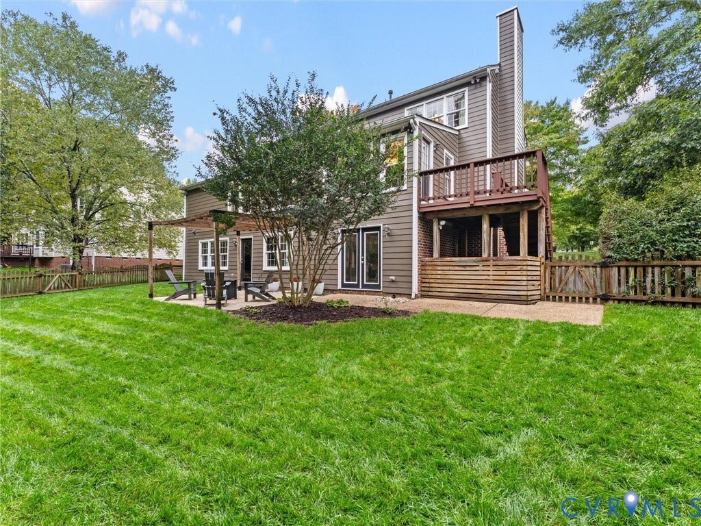 12100 English Ivy Lane, Glen Allen, VA 23059 Rear exterior featuring horizontal lap siding, an elevated wood deck, a covered patio with a timber pergola, and a fenced-in yard