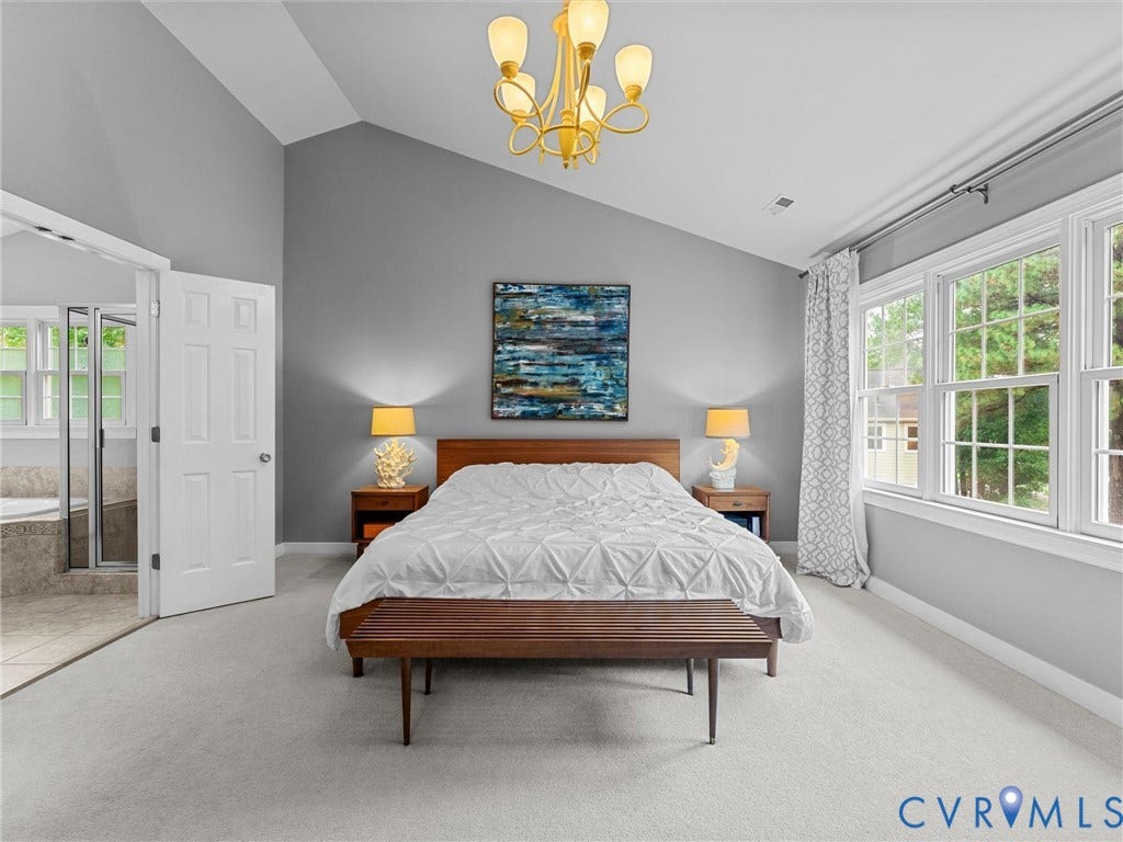 12100 English Ivy Lane, Glen Allen, VA 23059 Vaulted ceilings featuring a multi-arm chandelier, neutral carpeting, and multi-pane windows