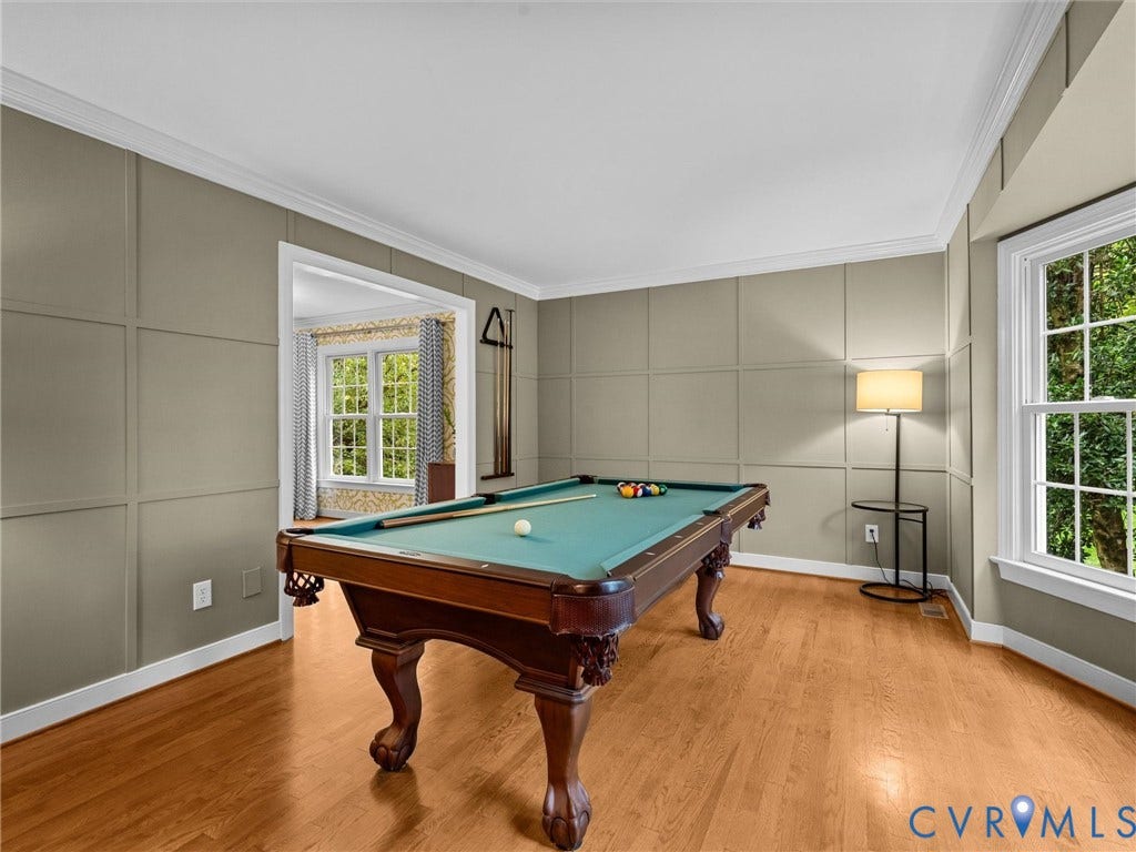 12100 English Ivy Lane, Glen Allen, VA 23059 Room featuring grid-pattern wall molding, wood-finish flooring, and a bay window with multi-pane glazing