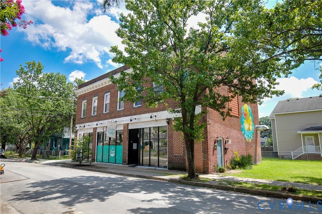 2021 North Avenue, Richmond, VA 23222 Brick facade building featuring ground-floor storefronts with large windows, upper-level windows, and a decorative cornice