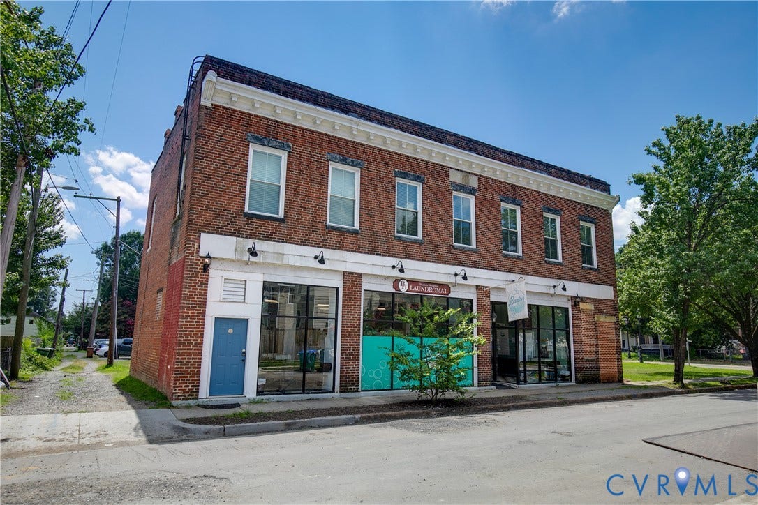 2021 North Avenue, Richmond, VA 23222 Brick facade building featuring multiple large storefront windows, a separate entrance, and a paved street