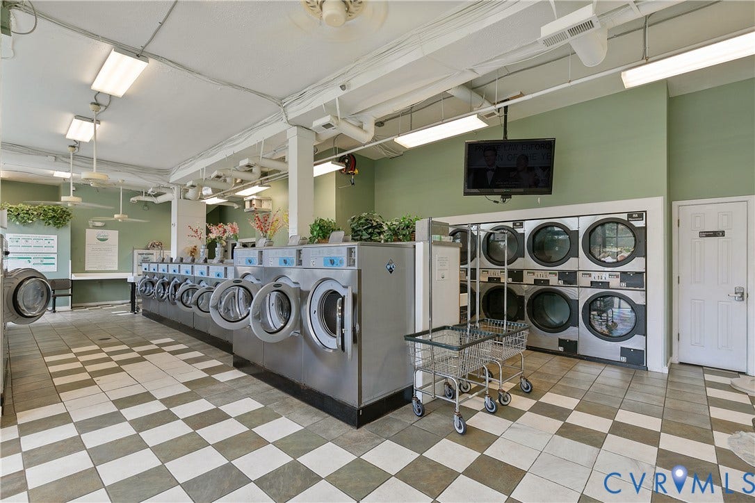 2021 North Avenue, Richmond, VA 23222 Checkered floor tiling, multiple front-loading washers, wall-mounted television, flush-mount ceiling lights, and exposed ceiling ductwork