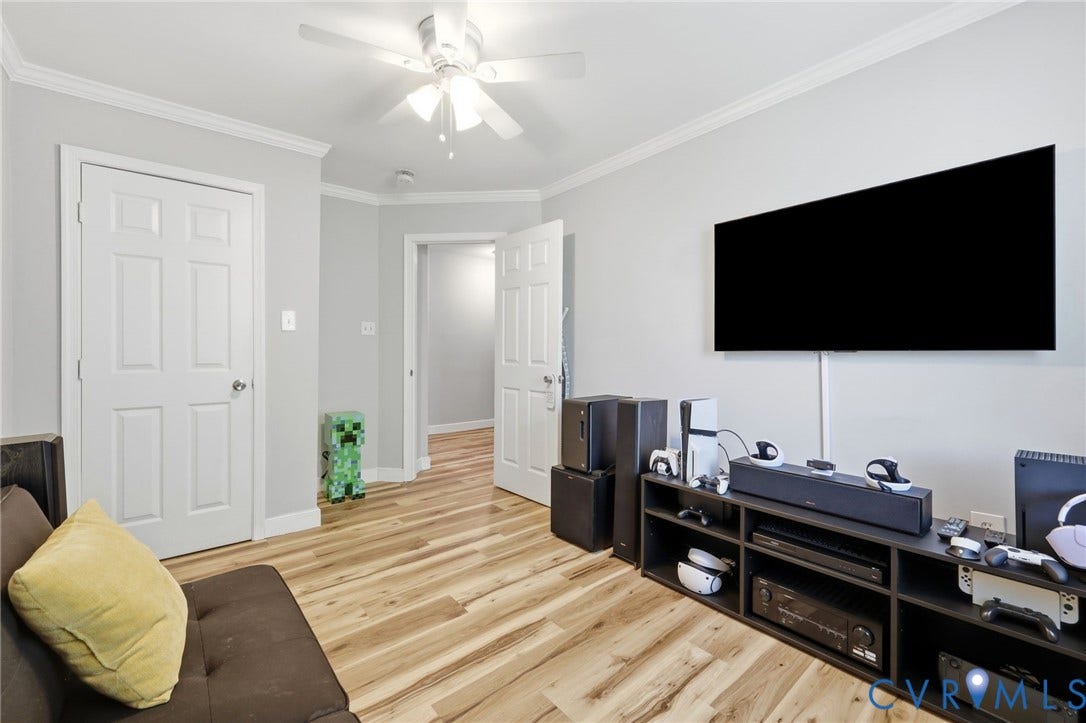 3015 M Street, Church Hill, Richmond, VA 23223 Wood-finish flooring, crown molding, ceiling fan, and white paneled doors
