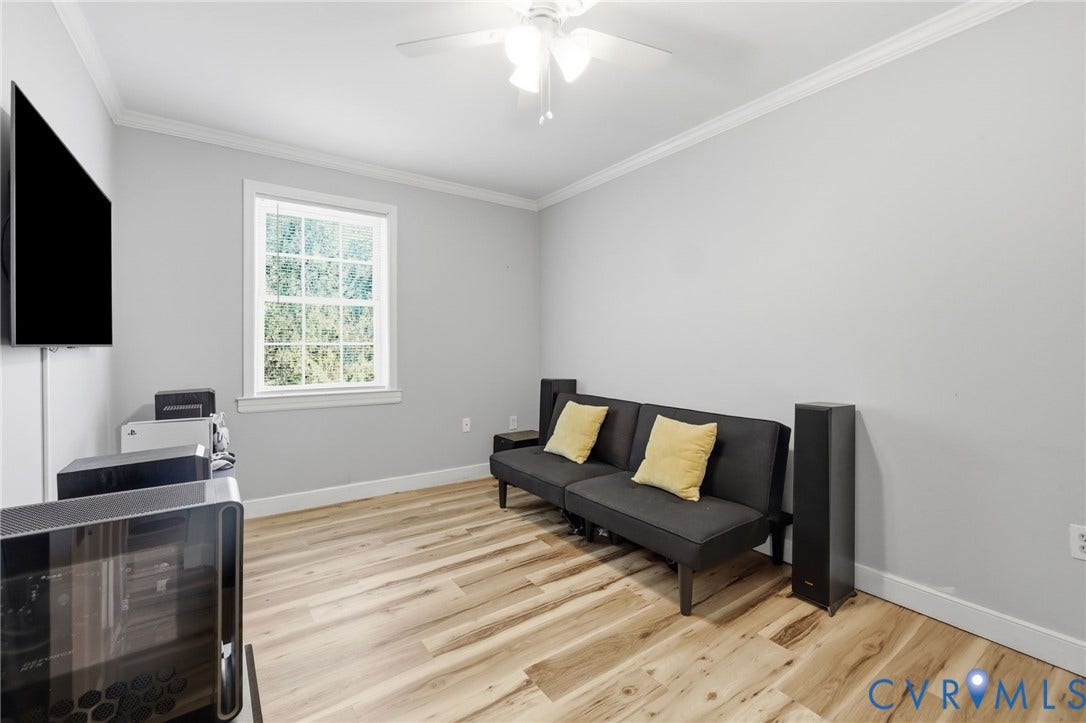 3015 M Street, Church Hill, Richmond, VA 23223 Wood-finish flooring, white trim, recessed window with grid, ceiling fan with light fixture, and light-toned walls