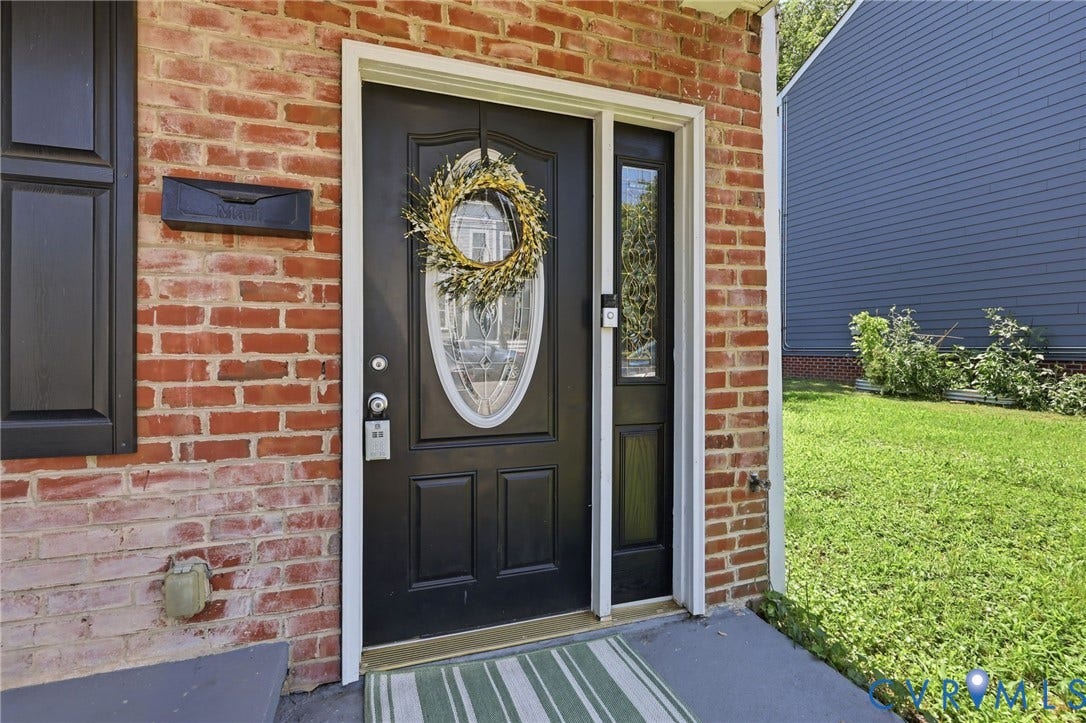 3015 M Street, Church Hill, Richmond, VA 23223 Brick exterior with black front door, decorative glass insert, and sidelight