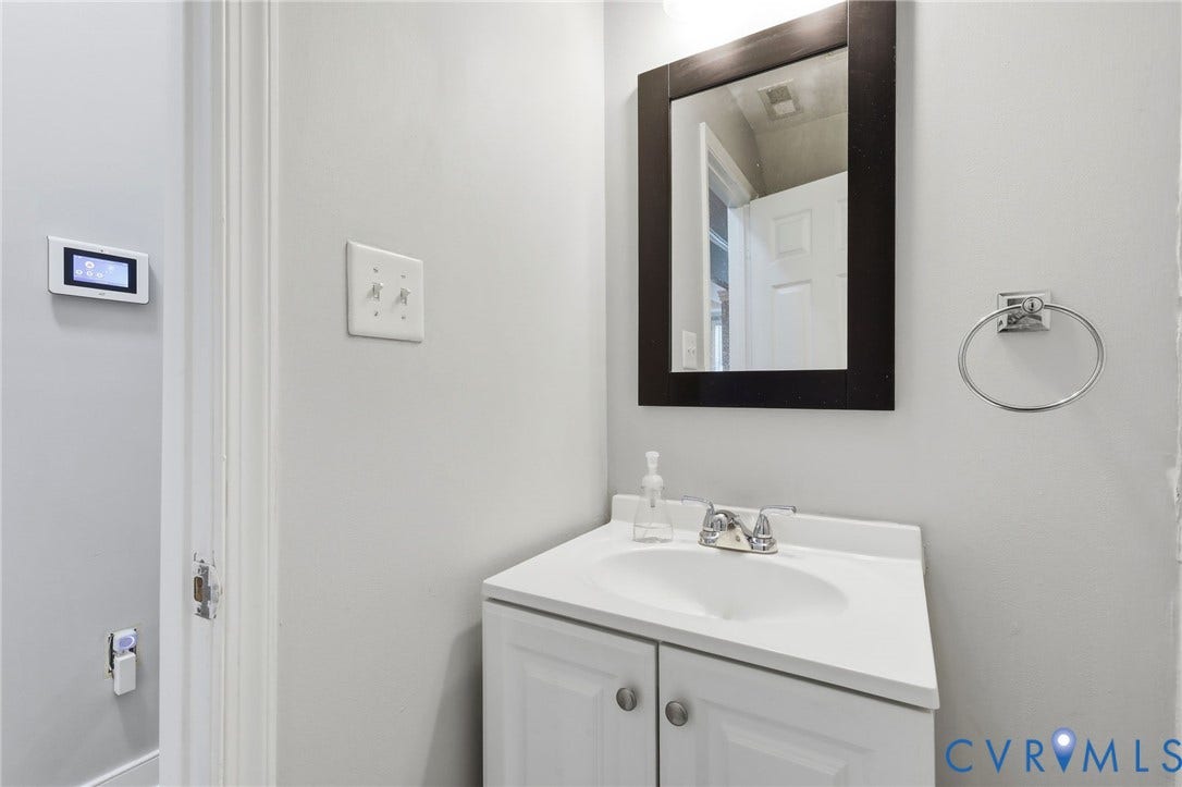 3015 M Street, Church Hill, Richmond, VA 23223 Vanity with integrated sink, mounted mirror, and chrome faucet