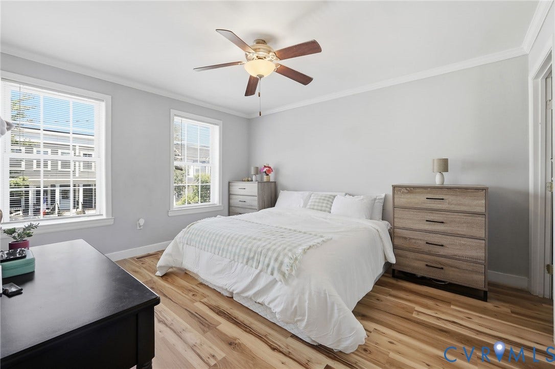 3015 M Street, Church Hill, Richmond, VA 23223 Light gray walls with crown molding, wood-finish flooring, and two double-hung windows