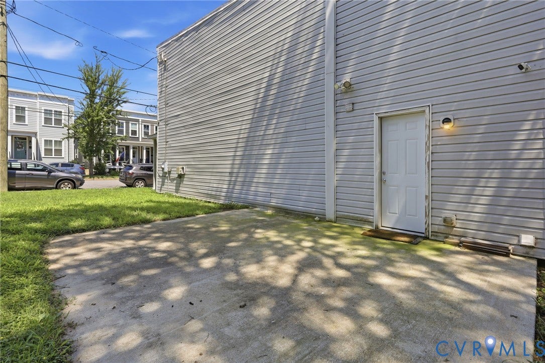 3015 M Street, Church Hill, Richmond, VA 23223 Concrete patio with direct entry, exterior wall lighting, and horizontal siding