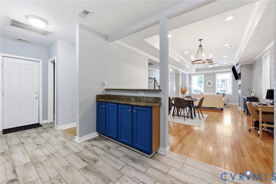 3015 M Street, Church Hill, Richmond, VA 23223 Wood-finish tile flooring at entry, built-in cabinetry with granite countertop, hardwood flooring in living areas, recessed lighting, and a prominent chandelier