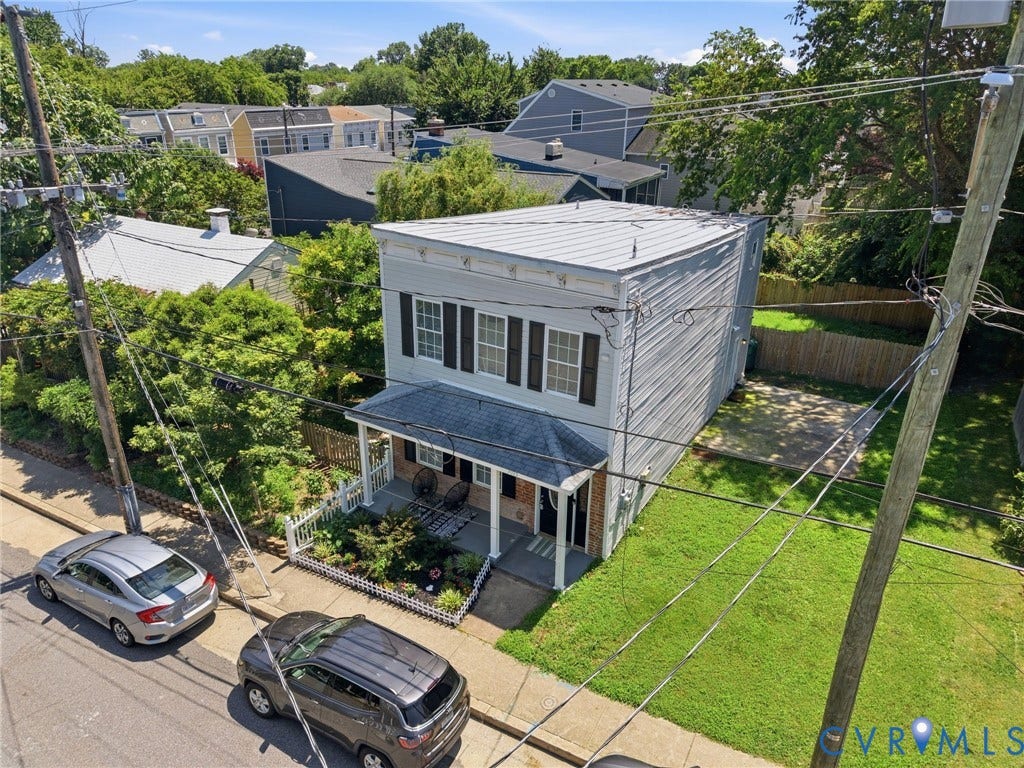 3015 M Street, Church Hill, Richmond, VA 23223 Two-story exterior with light-colored siding, a metal roof, and a covered front porch