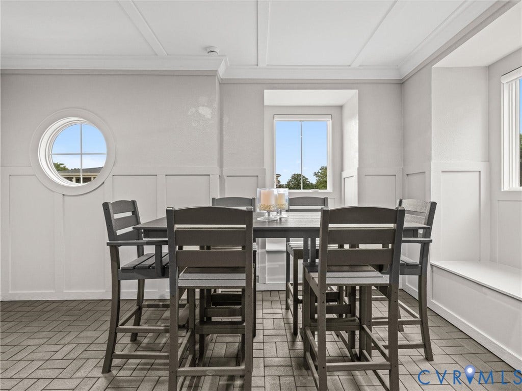 511 Libbie Avenue, #A, The Row At Westhampton, Richmond, VA 23226 Herringbone-patterned wood-finish flooring, wainscoting with board and batten detailing, recessed ceiling panels, a circular window, and a built-in window seat