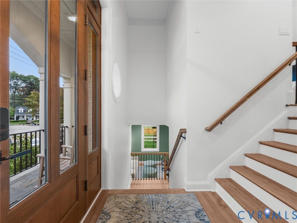 511 Libbie Avenue, #A, The Row At Westhampton, Richmond, VA 23226 Hardwood flooring, wood-finish staircase treads, wood handrails, and a prominent front door with glass panels