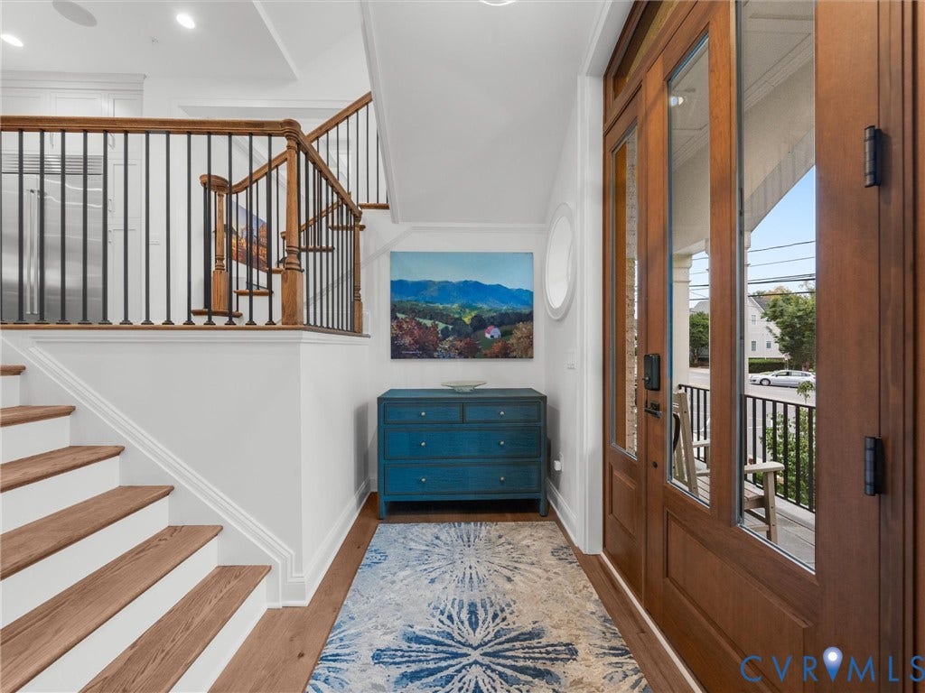 511 Libbie Avenue, #A, The Row At Westhampton, Richmond, VA 23226 Entryway featuring a wood-finish door with glass panels, hardwood flooring, and a staircase with wood-finish treads and metal balusters