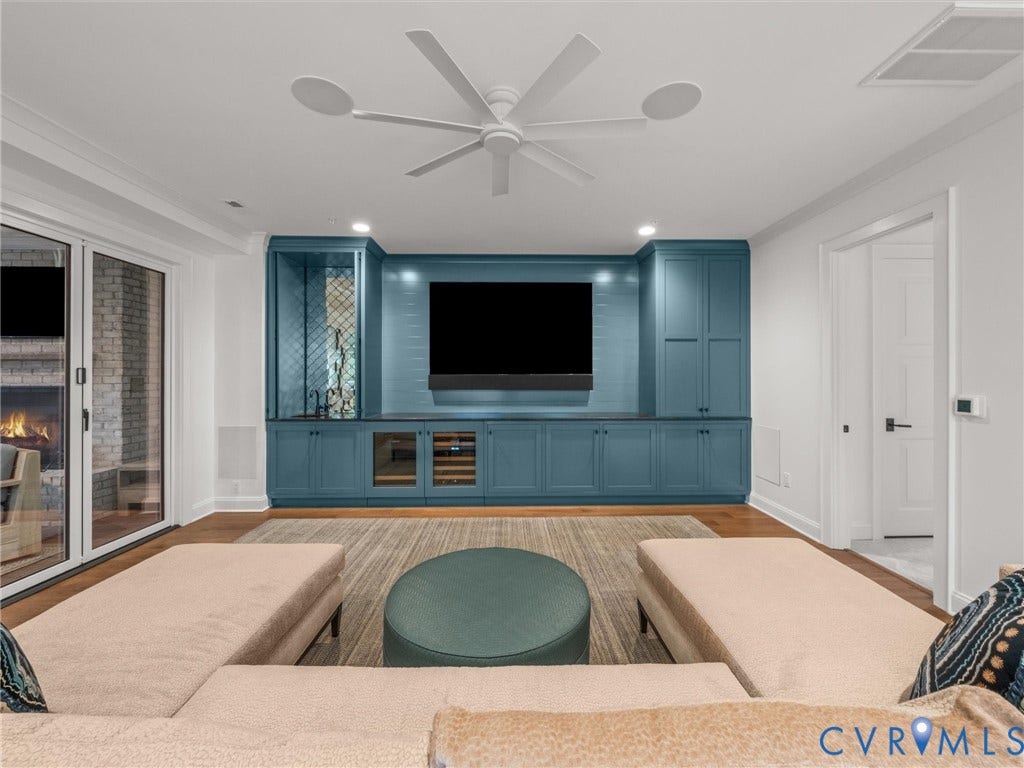511 Libbie Avenue, #A, The Row At Westhampton, Richmond, VA 23226 Built-in entertainment center with blue cabinetry, integrated beverage refrigerator, and open shelving