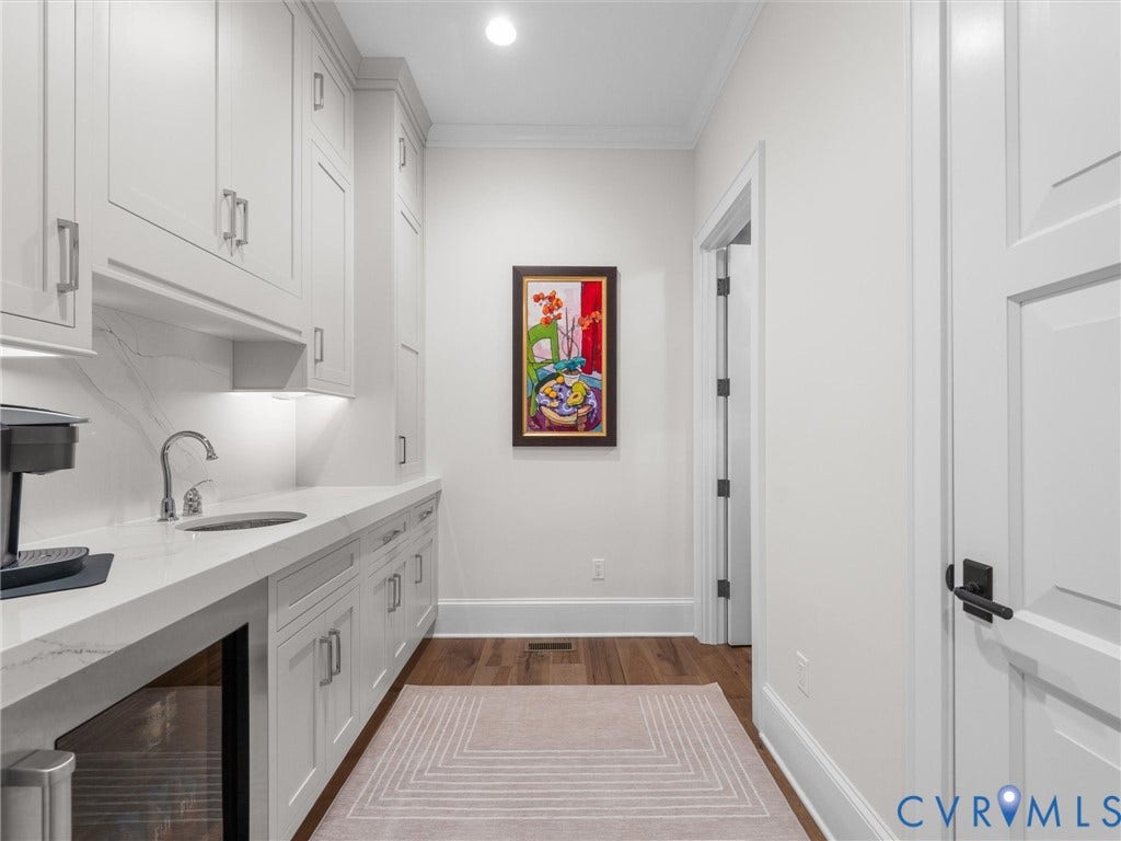 511 Libbie Avenue, #A, The Row At Westhampton, Richmond, VA 23226 Built-in cabinetry with under-cabinet lighting, stainless steel sink, wood-finish flooring, and crown molding
