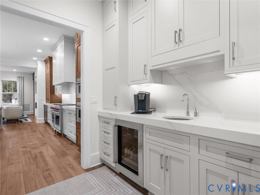 511 Libbie Avenue, #A, The Row At Westhampton, Richmond, VA 23226 White shaker cabinetry with a beverage cooler, undermount sink, and stone-finish countertop