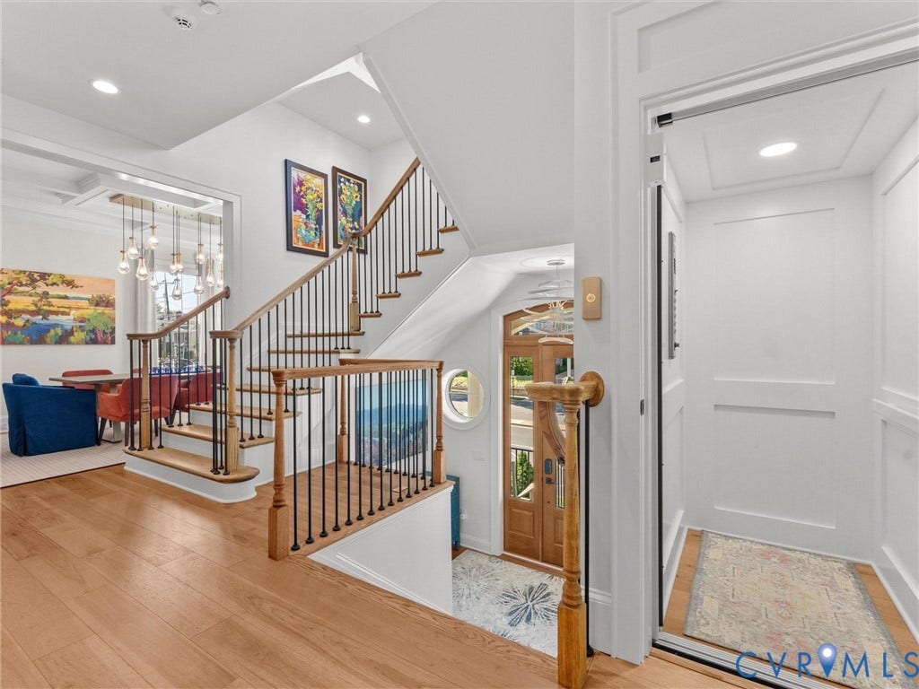 511 Libbie Avenue, #A, The Row At Westhampton, Richmond, VA 23226 Hardwood flooring, wood staircase with black iron balusters, recessed lighting, and a built-in elevator
