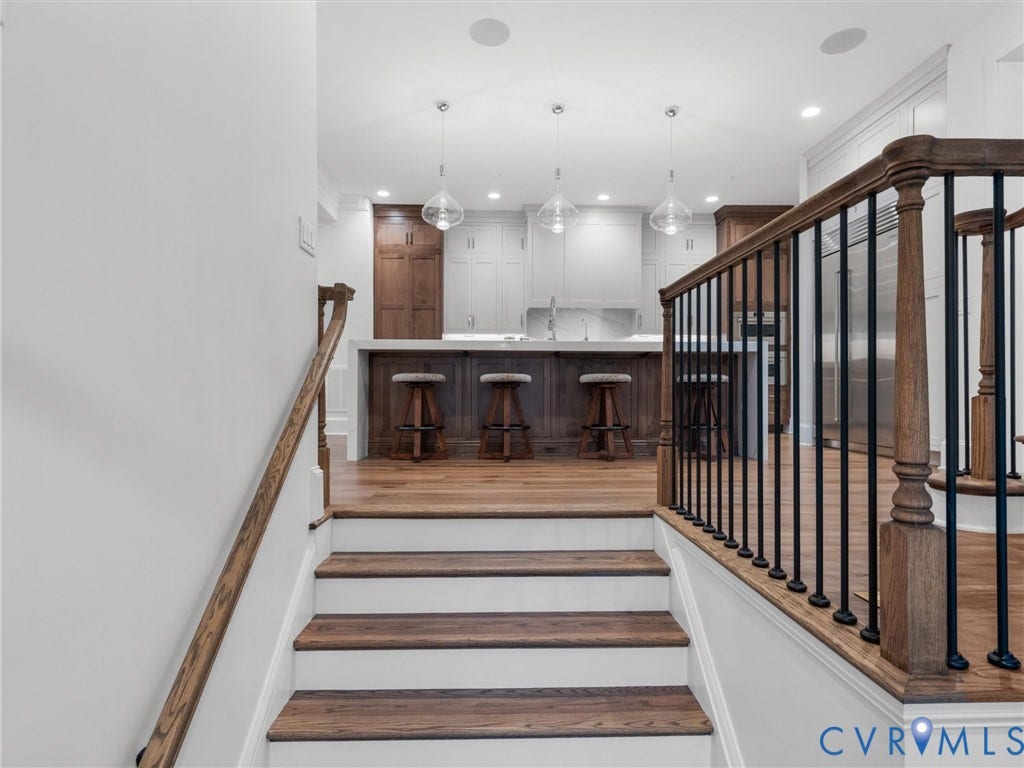 511 Libbie Avenue, #A, The Row At Westhampton, Richmond, VA 23226 Staircase with wood-finish treads and risers, featuring a wood-finish handrail and black iron balusters