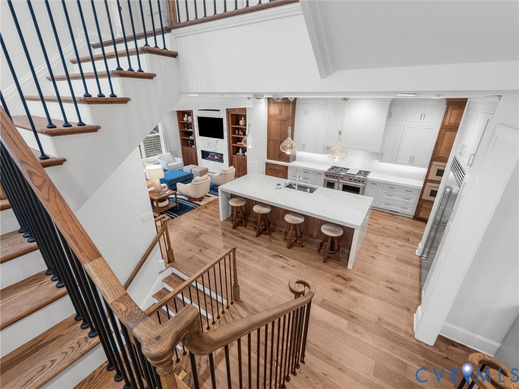 511 Libbie Avenue, #A, The Row At Westhampton, Richmond, VA 23226 Open-concept design featuring wood-finish flooring, a gourmet kitchen with a central island and white countertops, built-in shelving, and a fireplace