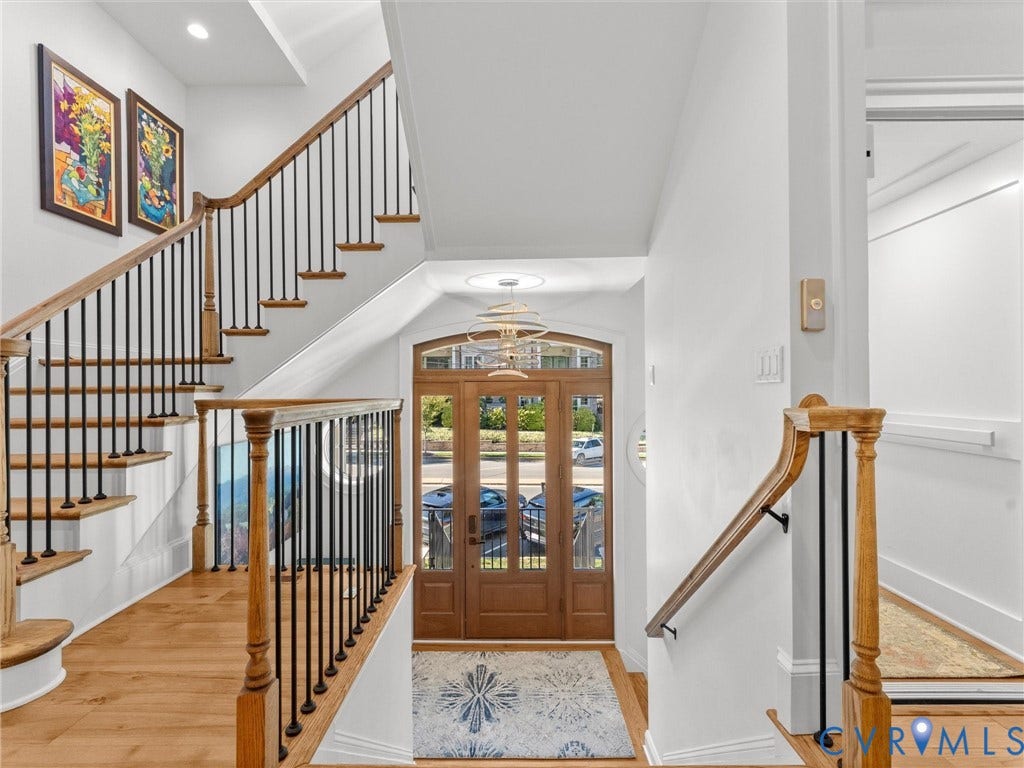 511 Libbie Avenue, #A, The Row At Westhampton, Richmond, VA 23226 Grand entryway featuring wood-finish flooring, a wood front door with glass panels, and a staircase with wood treads and black iron balusters