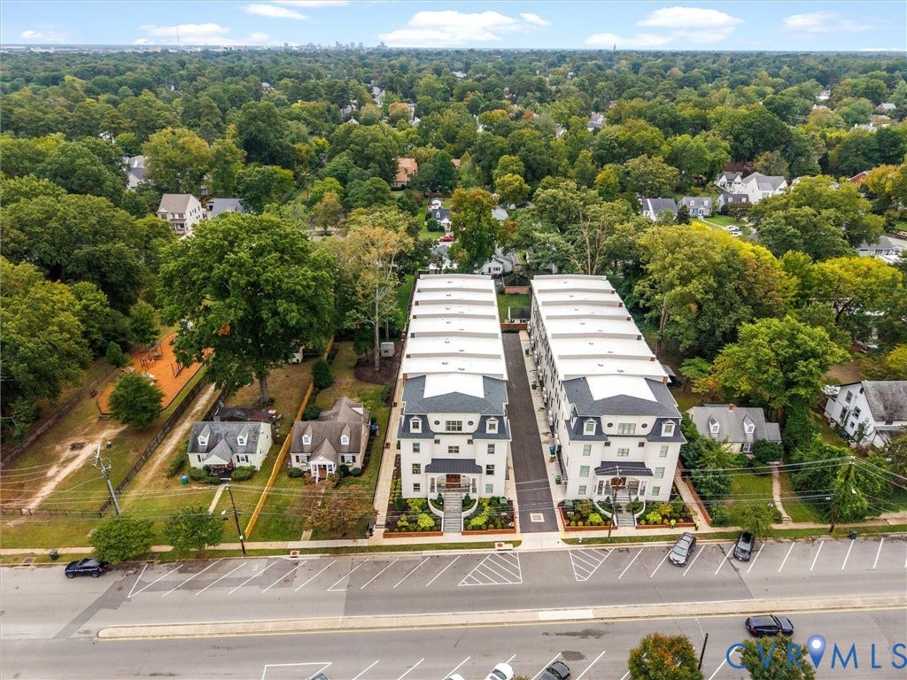 511 Libbie Avenue, #A, The Row At Westhampton, Richmond, VA 23226 Colonial-style townhomes featuring multiple levels, dormer windows, and mature landscaping