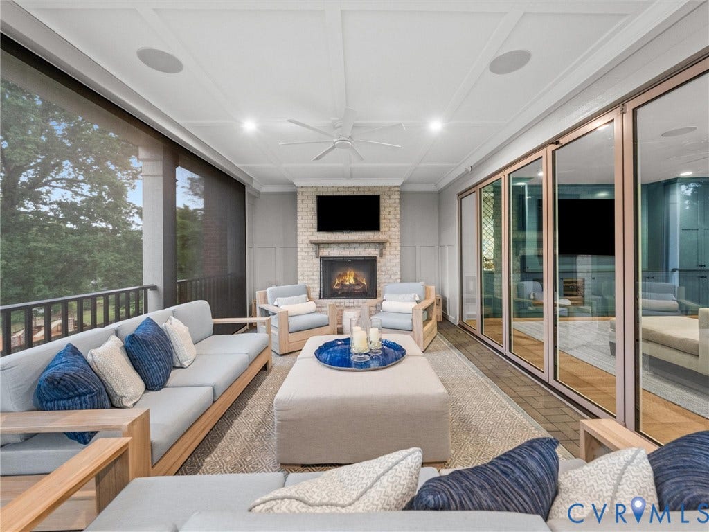 511 Libbie Avenue, #A, The Row At Westhampton, Richmond, VA 23226 Screened porch featuring a brick fireplace, built-in ceiling speakers, wood-finish flooring, and multi-panel sliding glass doors