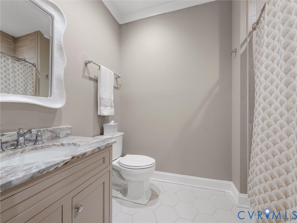 511 Libbie Avenue, #A, The Row At Westhampton, Richmond, VA 23226 Vanity with a polished stone countertop, undermount sink, and chrome faucet