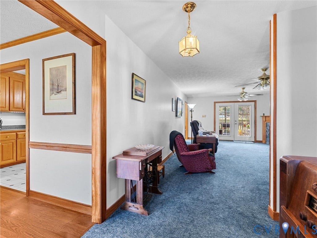 5325 Swift Hill Lane, Scandia Lake, Sandston, VA 23150 Recessed wood-trimmed entry, wood-finish flooring, white painted walls, french doors, and built-in ceiling fans