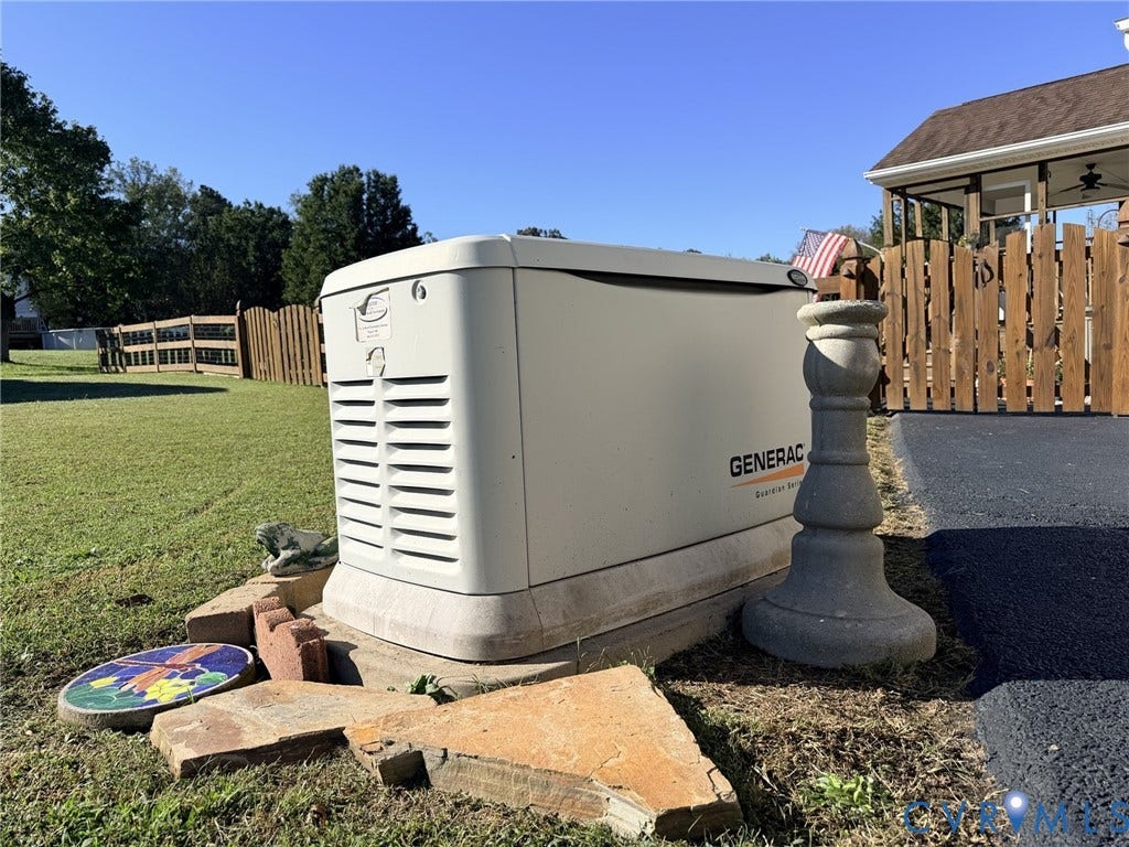 5325 Swift Hill Lane, Scandia Lake, Sandston, VA 23150 Generac standby generator on a concrete pad, bordered by a wood privacy fence and a manicured lawn