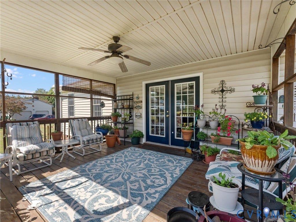 5325 Swift Hill Lane, Scandia Lake, Sandston, VA 23150 Screened porch featuring a wood-finish floor, white paneled ceiling, and a ceiling fan