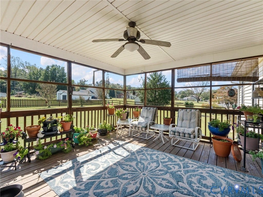 5325 Swift Hill Lane, Scandia Lake, Sandston, VA 23150 Screened porch featuring a paneled ceiling, ceiling fan, wood-finish decking, and slatted railings