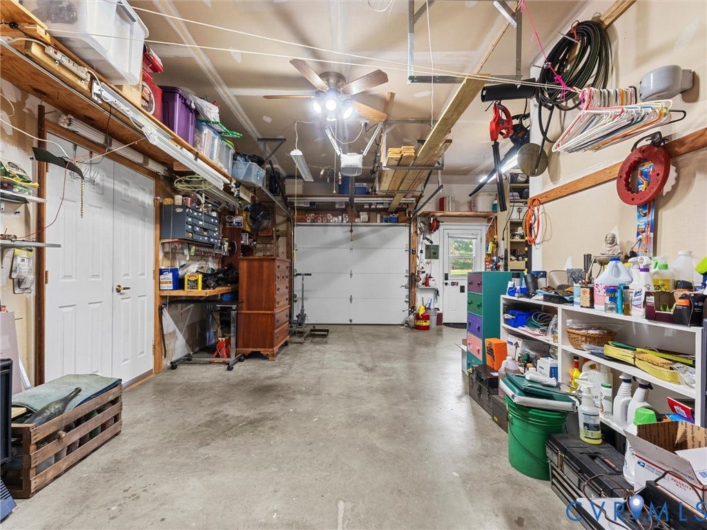 5325 Swift Hill Lane, Scandia Lake, Sandston, VA 23150 Concrete flooring in a spacious garage with a white overhead door