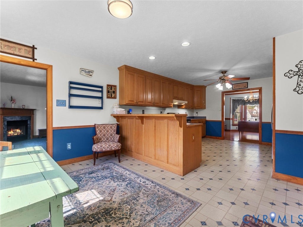 5325 Swift Hill Lane, Scandia Lake, Sandston, VA 23150 Kitchen with wood cabinetry, a breakfast bar, and patterned floor tiles