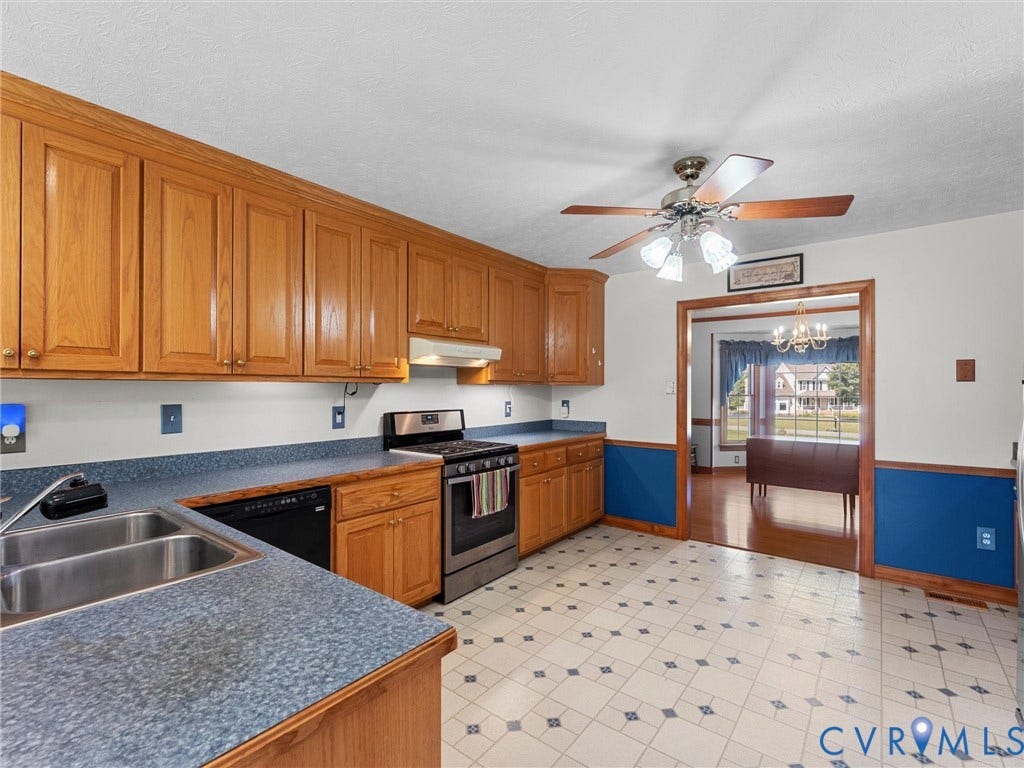 5325 Swift Hill Lane, Scandia Lake, Sandston, VA 23150 Kitchen featuring wood cabinetry, a stainless steel gas range, a double basin sink, and patterned floor tiling