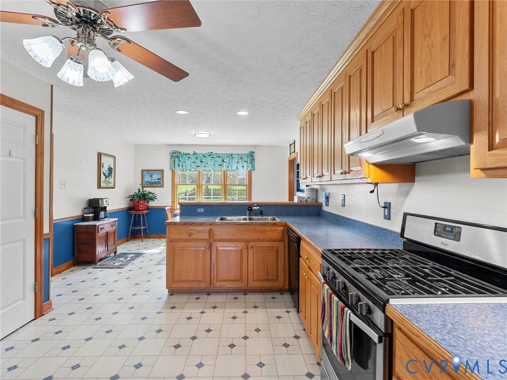 5325 Swift Hill Lane, Scandia Lake, Sandston, VA 23150 Full kitchen featuring wood cabinetry, integrated stainless steel range, and blue countertops