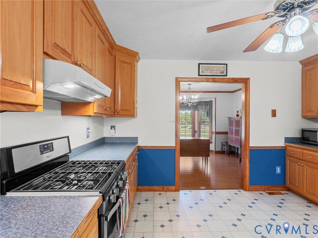 5325 Swift Hill Lane, Scandia Lake, Sandston, VA 23150 Kitchen featuring wood cabinetry, blue countertops, a stainless steel gas range, and a ceiling fan