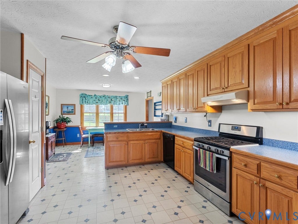 5325 Swift Hill Lane, Scandia Lake, Sandston, VA 23150 Kitchen featuring wood-finish cabinetry, blue countertops, stainless steel appliances, and patterned flooring