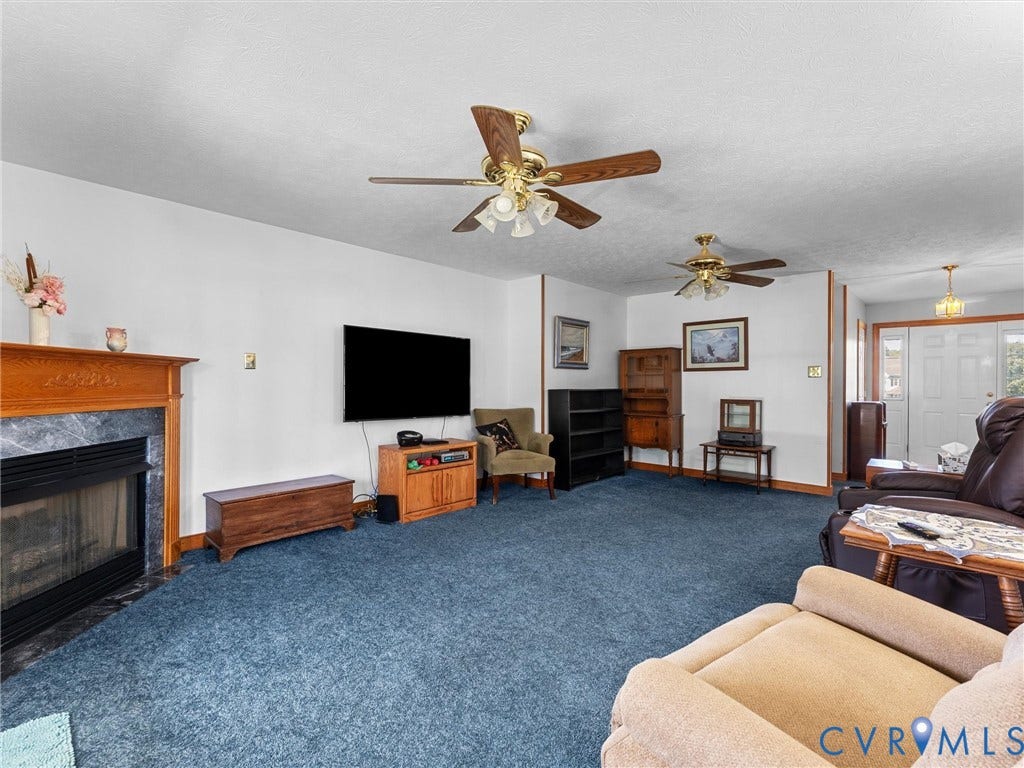 5325 Swift Hill Lane, Scandia Lake, Sandston, VA 23150 Fireplace with a stone surround and wood mantel