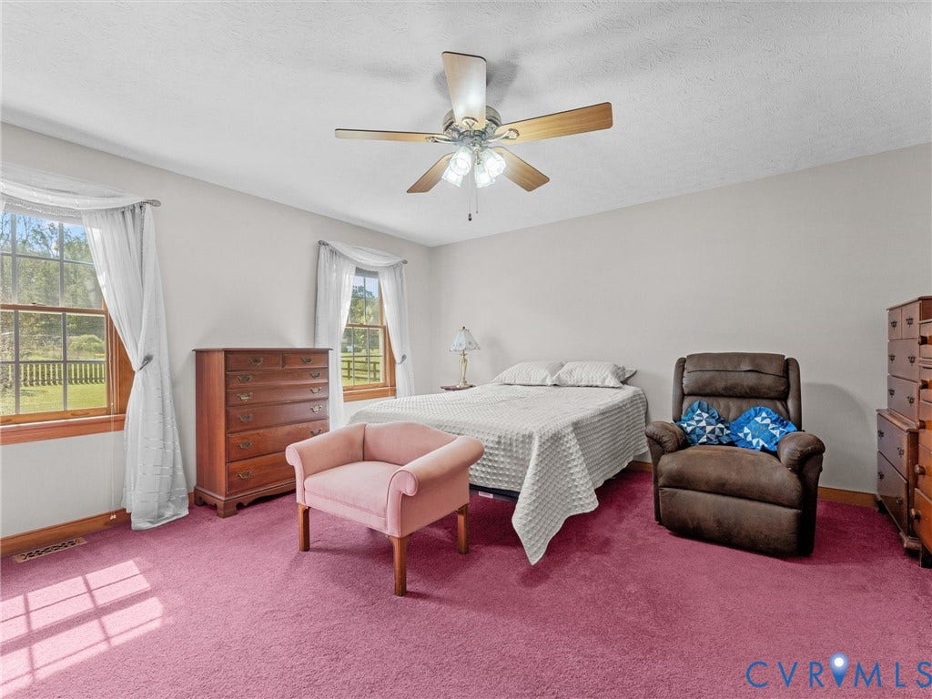 5325 Swift Hill Lane, Scandia Lake, Sandston, VA 23150 Room with two windows, a ceiling fan, and wall-to-wall carpeting
