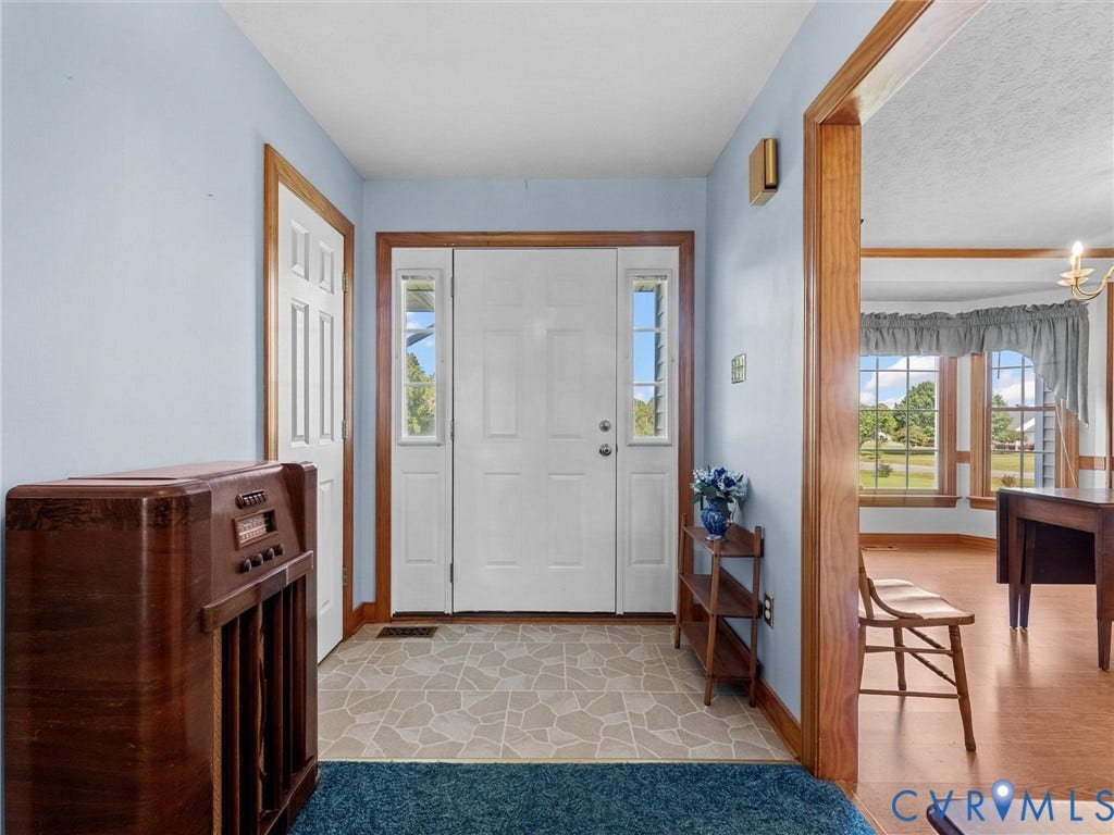 5325 Swift Hill Lane, Scandia Lake, Sandston, VA 23150 Entryway featuring a white paneled door, sidelight windows, and patterned tile flooring