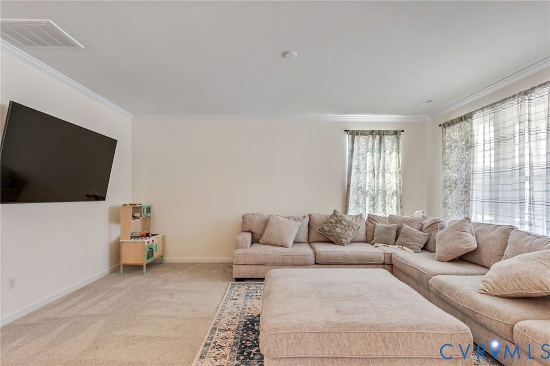 Recessed ceiling lighting, crown molding, and light-toned wall finishes