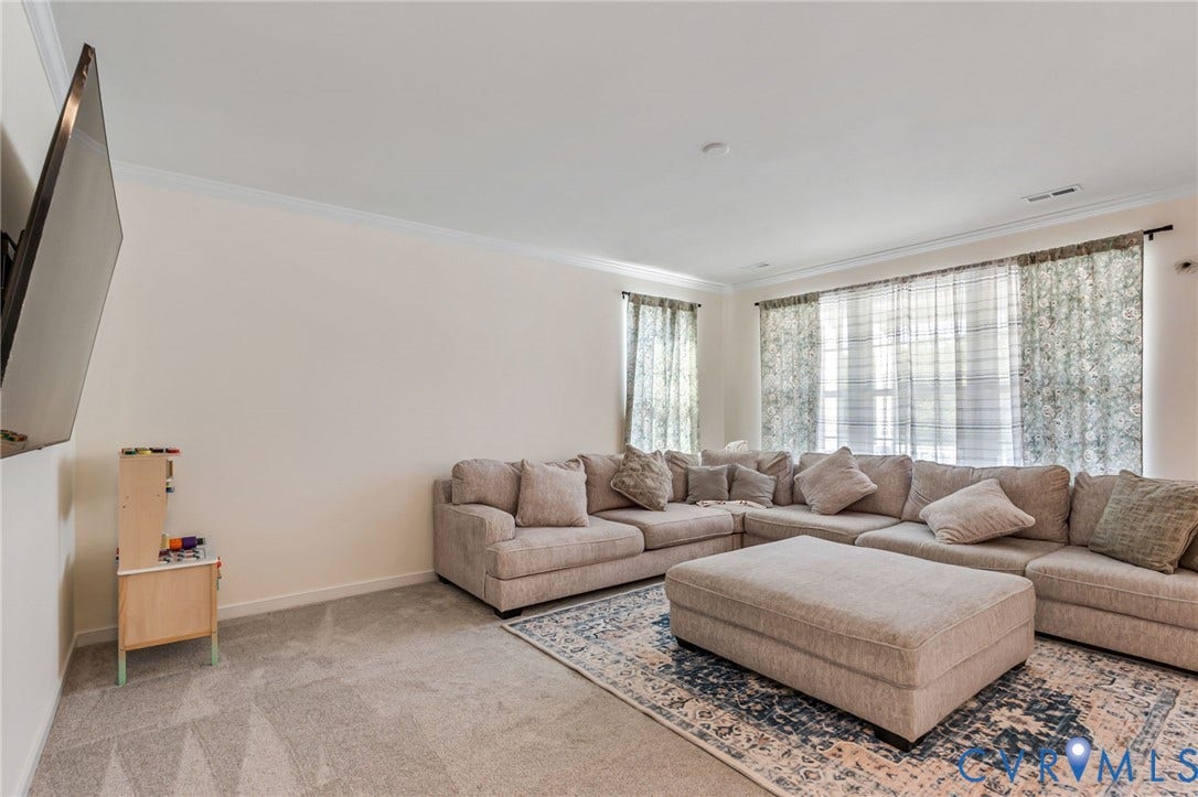Recessed ceiling lighting, crown molding, and neutral wall tones
