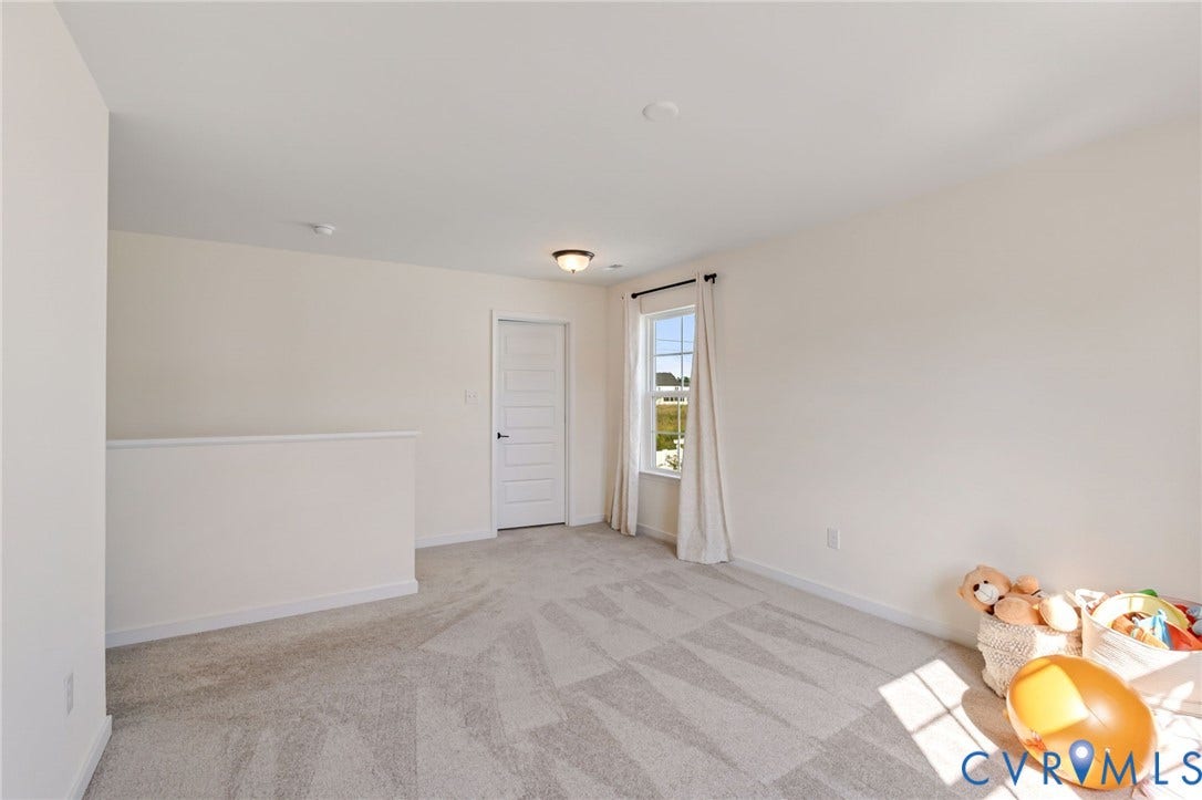 Neutral wall finishes with a single window, recessed lighting, and a paneled door