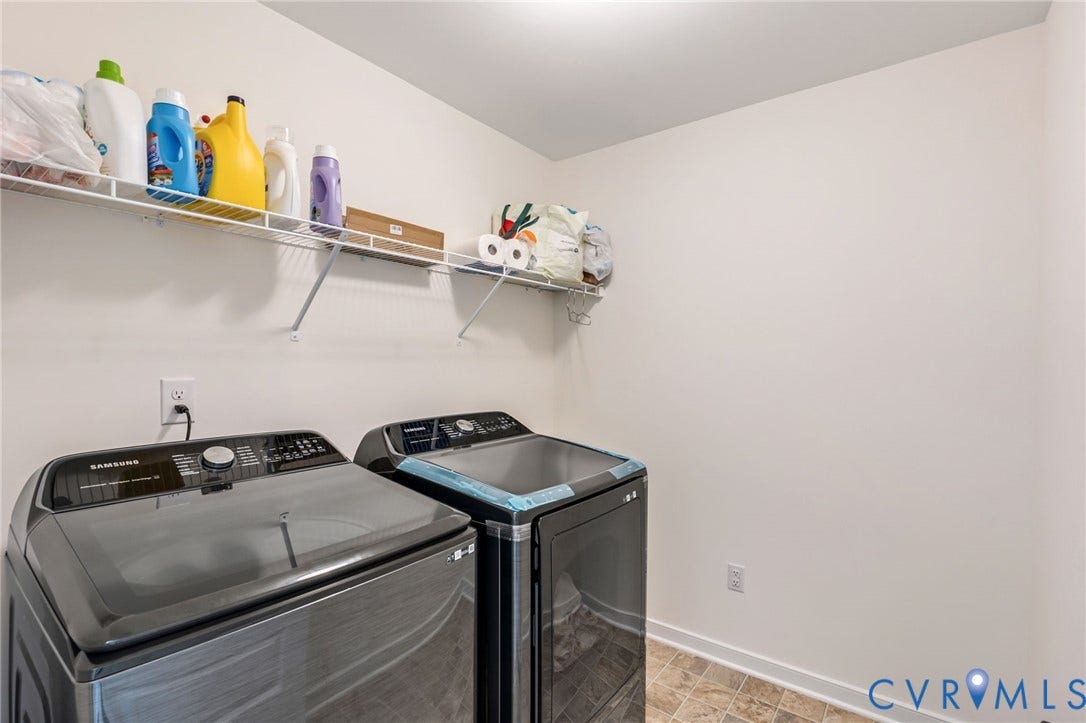 Functional utility room featuring wire shelving and durable flooring