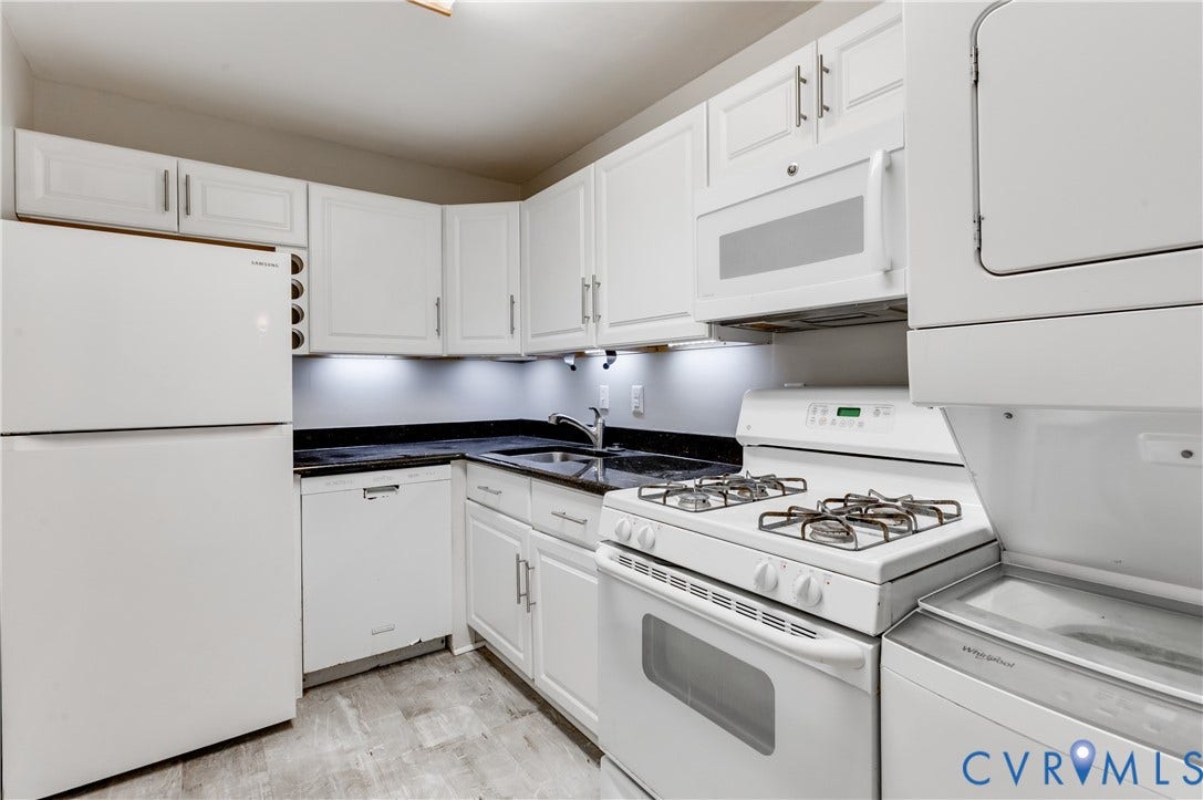 6 Stillwater Lane, Henrico, VA 23228 White cabinetry, dark countertops, built-in microwave, gas range, and wood-finish flooring