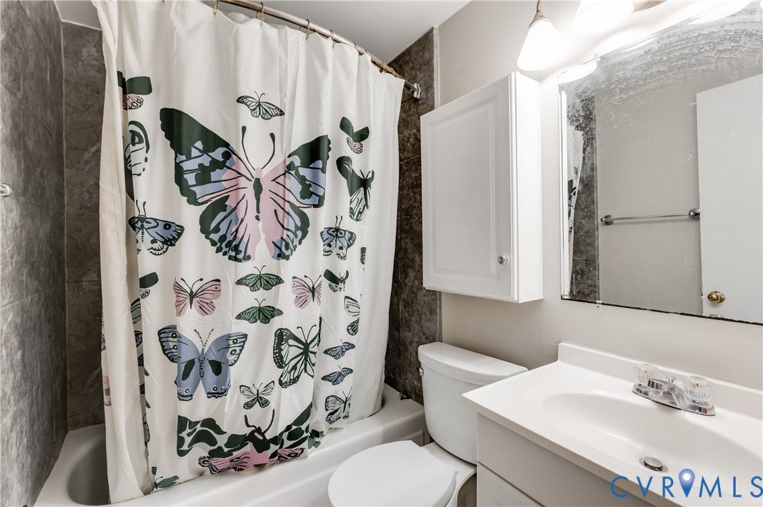 6 Stillwater Lane, Henrico, VA 23228 White vanity with a single basin sink, wall-mounted medicine cabinet, and a framed mirror