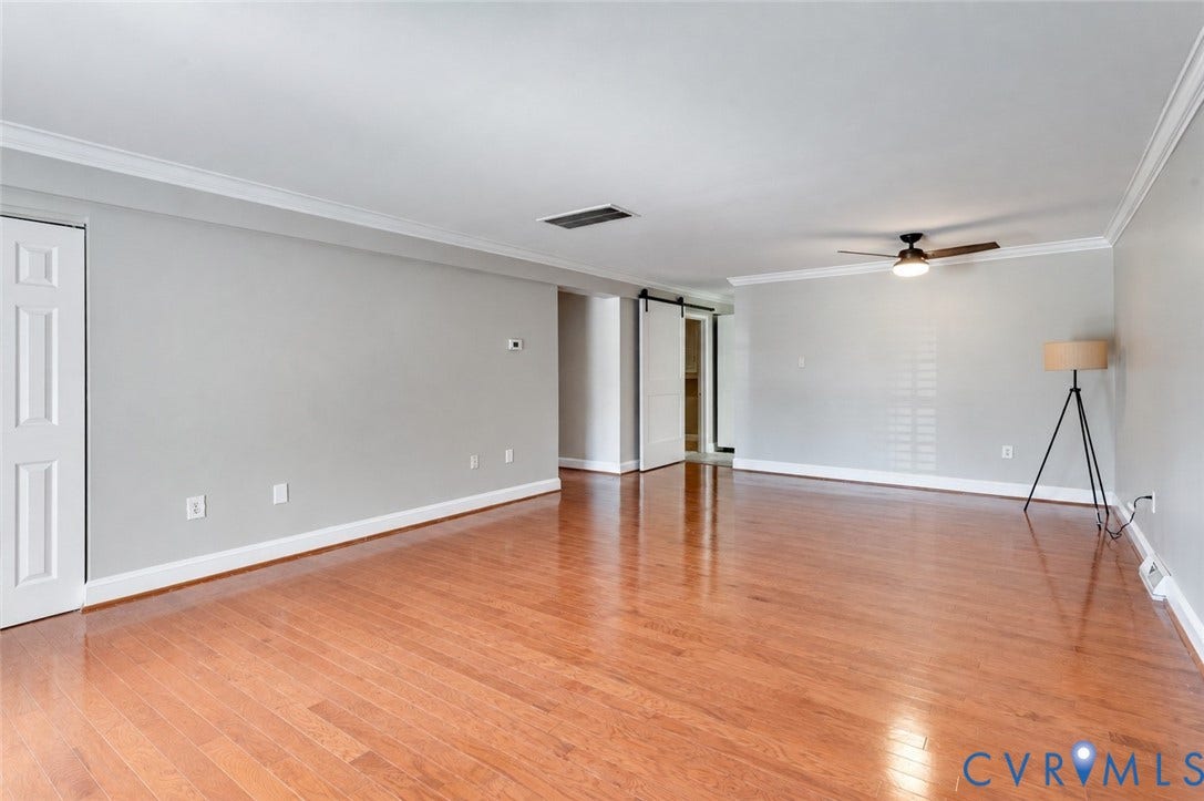6 Stillwater Lane, Henrico, VA 23228 Hardwood-finish flooring, white crown molding, light gray wall finishes, a ceiling fan with integrated lighting, and a white barn door