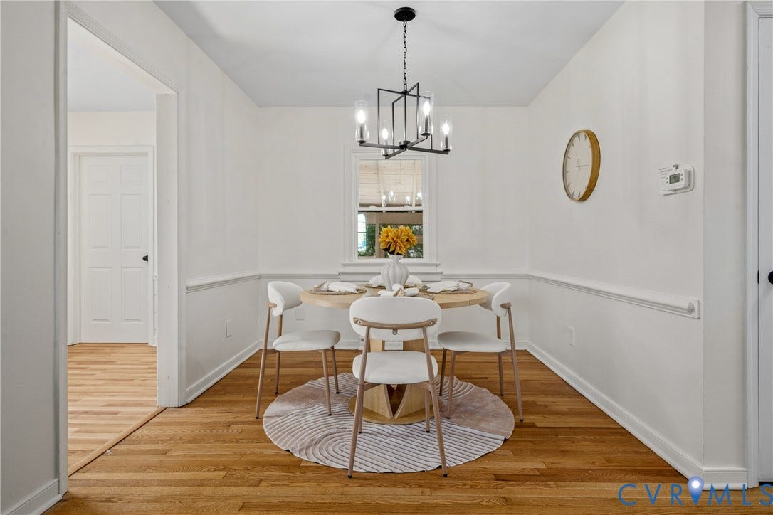 Hardwood flooring, painted trim, painted walls, built-in window, and a chandelier with a black finish