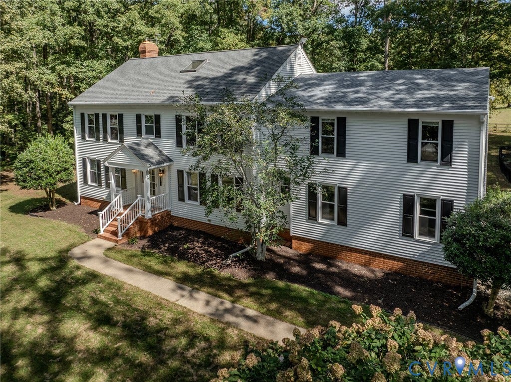 3120 McQuinn Road, Powhatan, VA 23139 Traditional colonial-style residence featuring white siding, a covered front porch