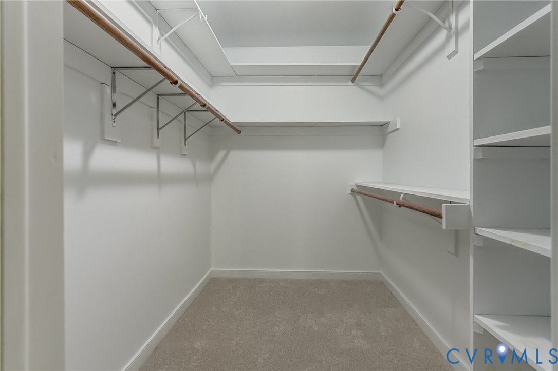 3120 McQuinn Road, Powhatan, VA 23139 Primary bedroom walk in closet with wood shelving